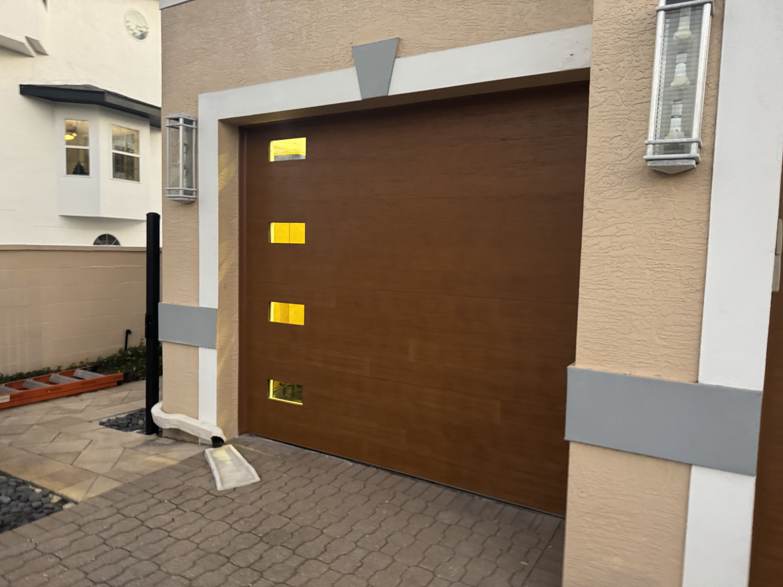 Modern brown flush garage door with vertical window inserts
