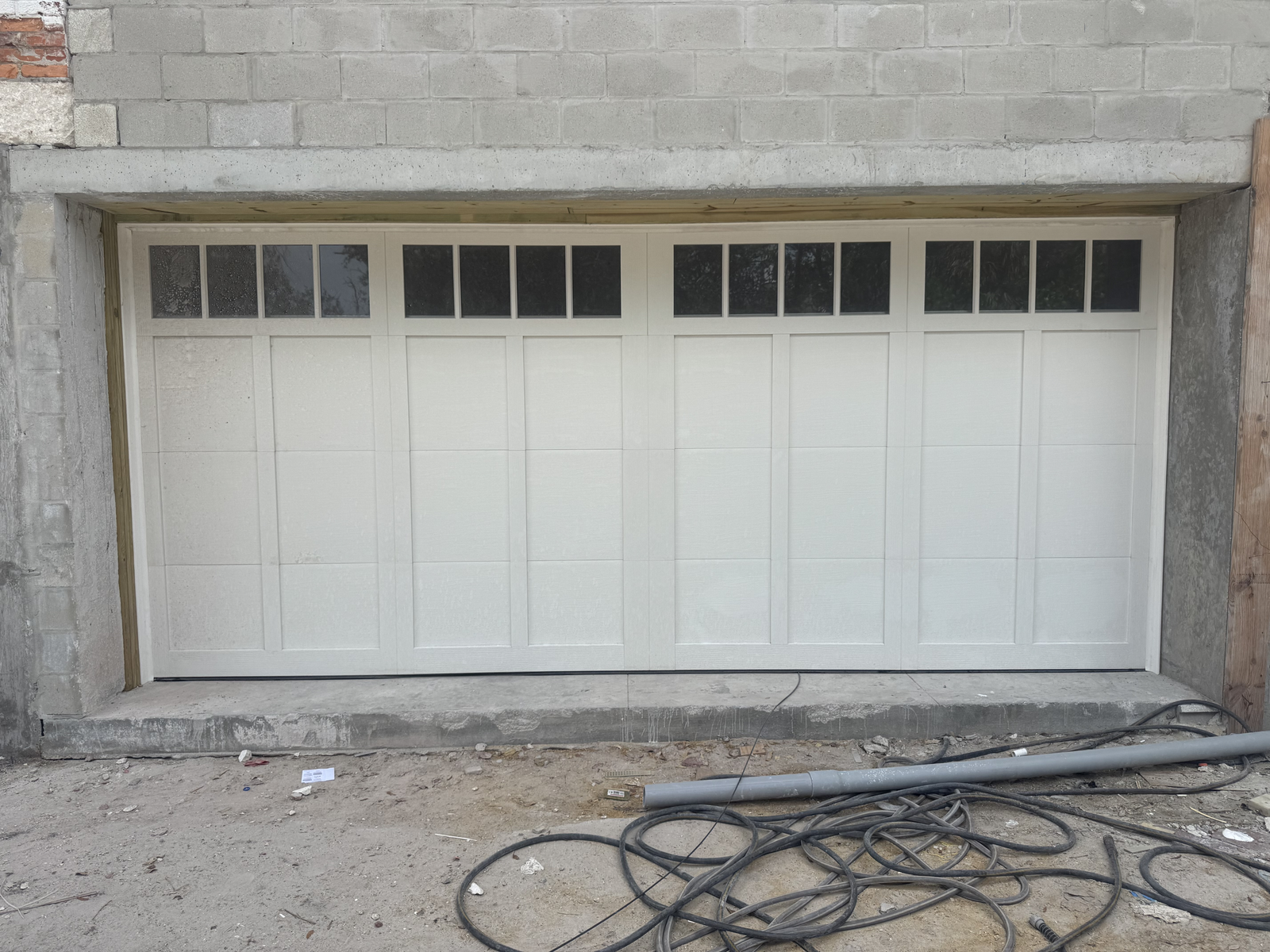 White carriage-style double garage door with top windows
