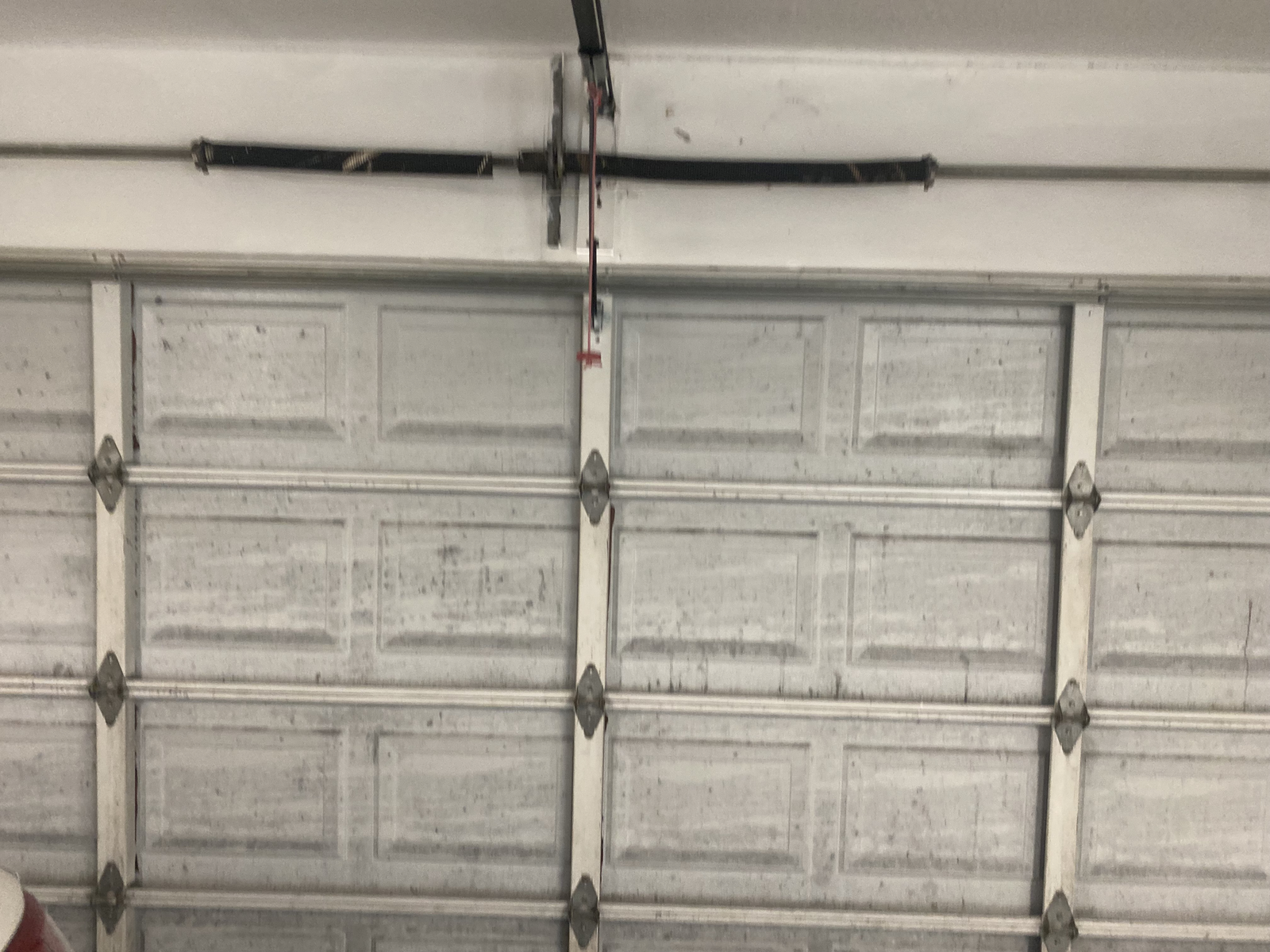 Inside view of a garage door with its torsion spring and hardware
