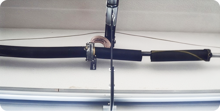 Broken garage door torsion spring before repair
